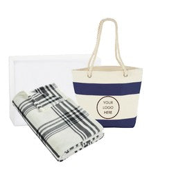 BirdieBox Beach Days Relaxation Gift Set: navy and white striped canvas tote bag with rope handles and a folded black, white, and grey plaid blanket.