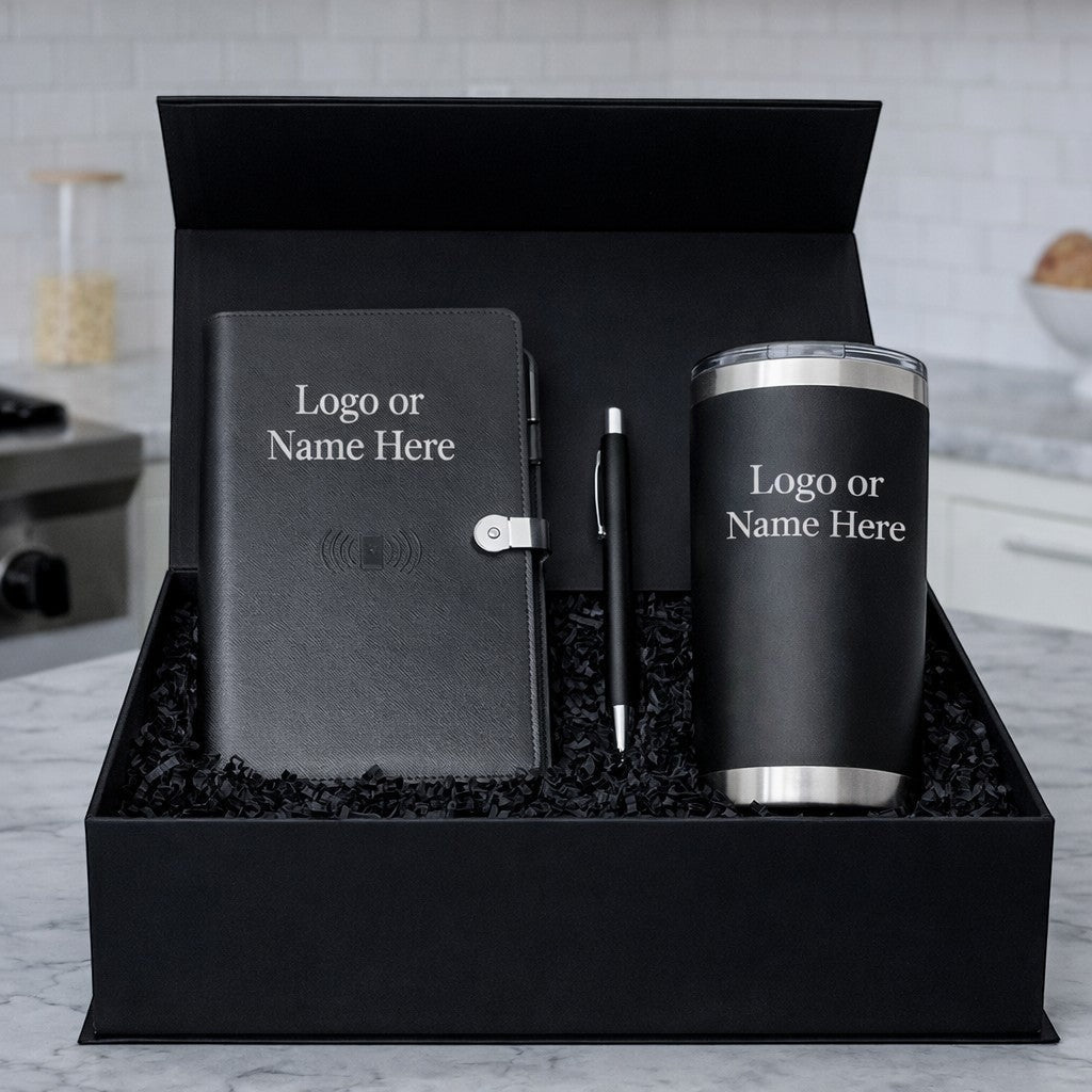 BirdieBox Executive Tech gift set includes a black journal with wireless charging, a black stylus pen, and a black tumbler, all in a black gift box with crinkle paper.