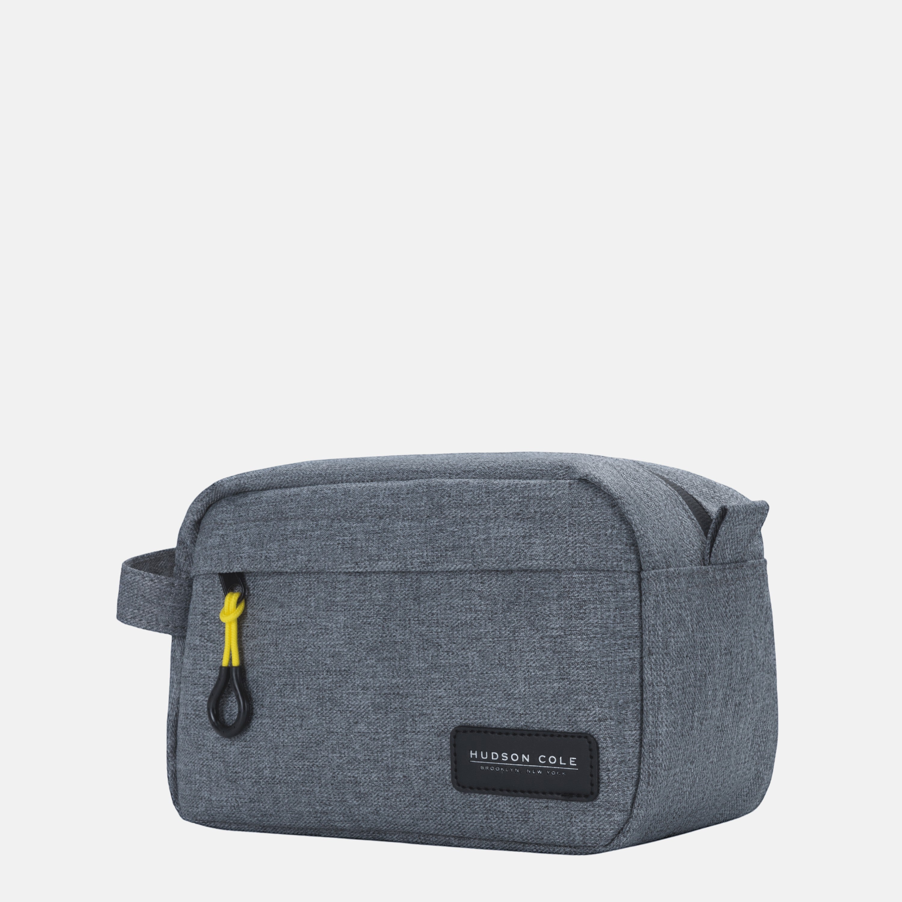 BirdieBox Hudson Cole Bedford Dopp Kit in grey canvas with yellow zipper pull and exterior strap.
