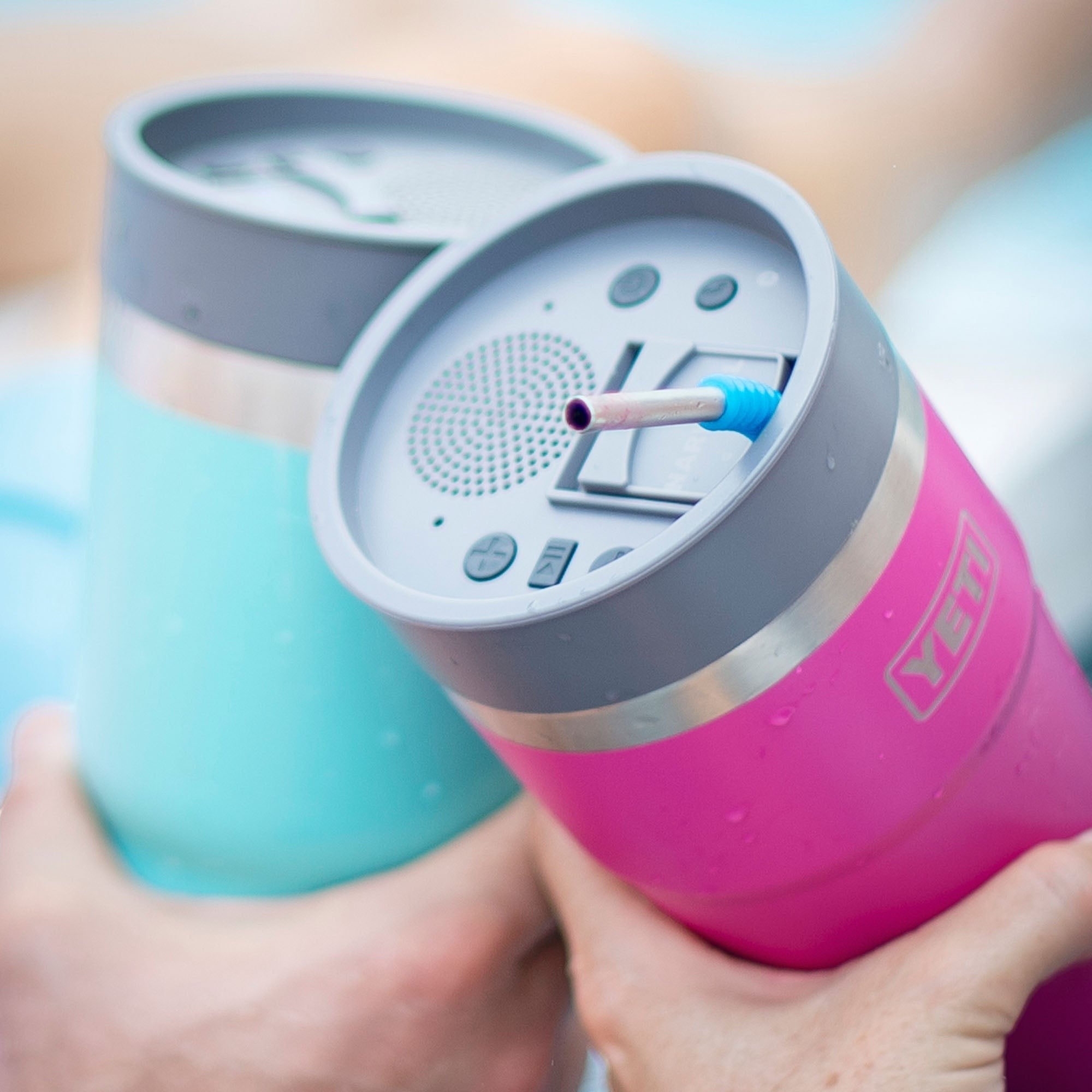 BirdieBox pink and teal tumblers with integrated Bluetooth speaker lids and straws. Controls on lid.