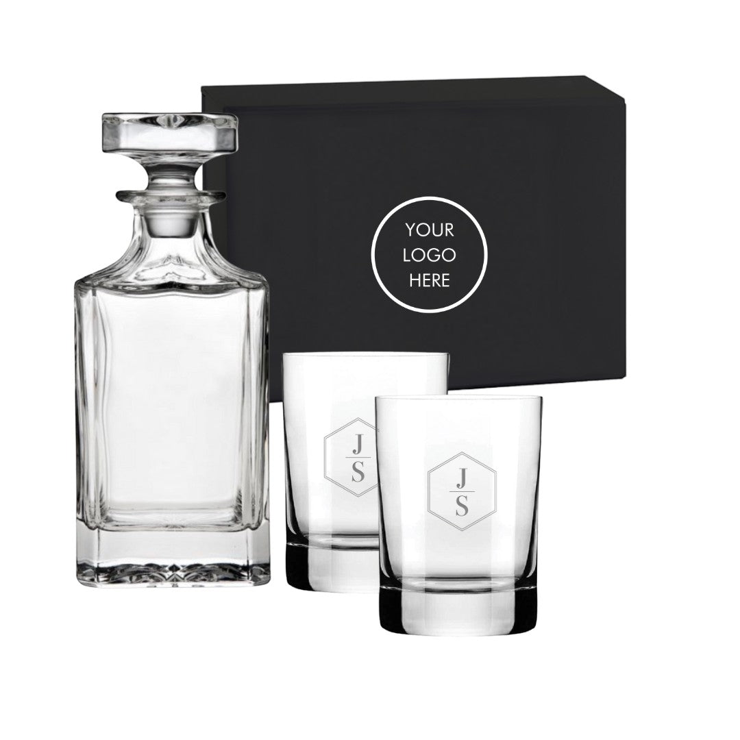 BirdieBox Decanter Delights Gift Set: Crystal decanter and two personalized rocks glasses with 'JS' monogram, presented in a black gift box.