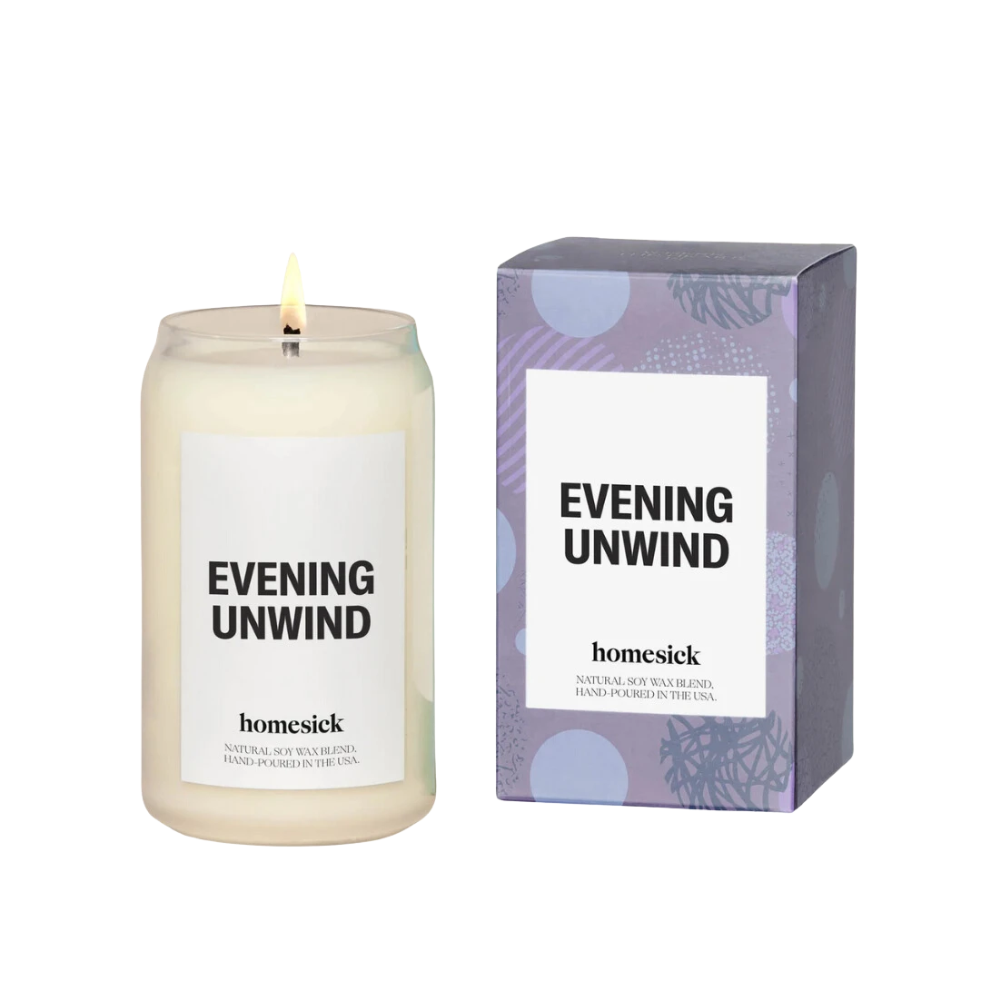 BirdieBox Homesick Evening Unwind candle in a clear glass jar with a lit wick. Natural soy wax blend, hand-poured in the USA.