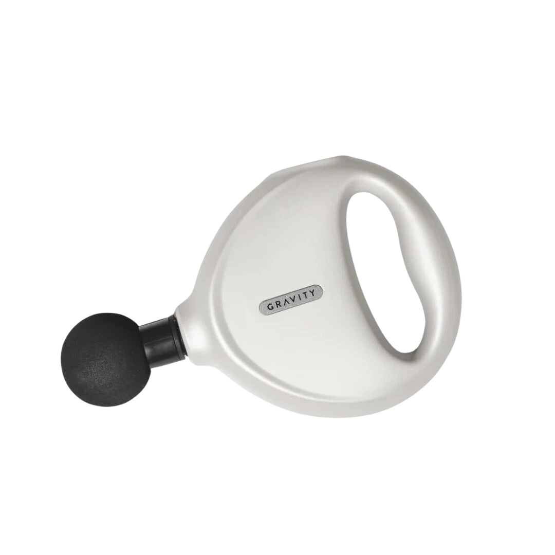 BirdieBox Gravity Move white heated mini massager with black attachment for on-the-go recovery and muscle relief.