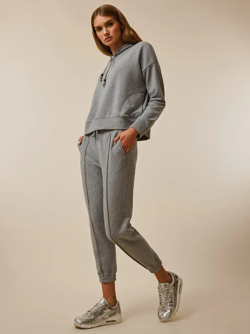 BirdieBox Greyson Women's grey heathered fleece hoodie with drawstring and front pocket, paired with matching joggers.