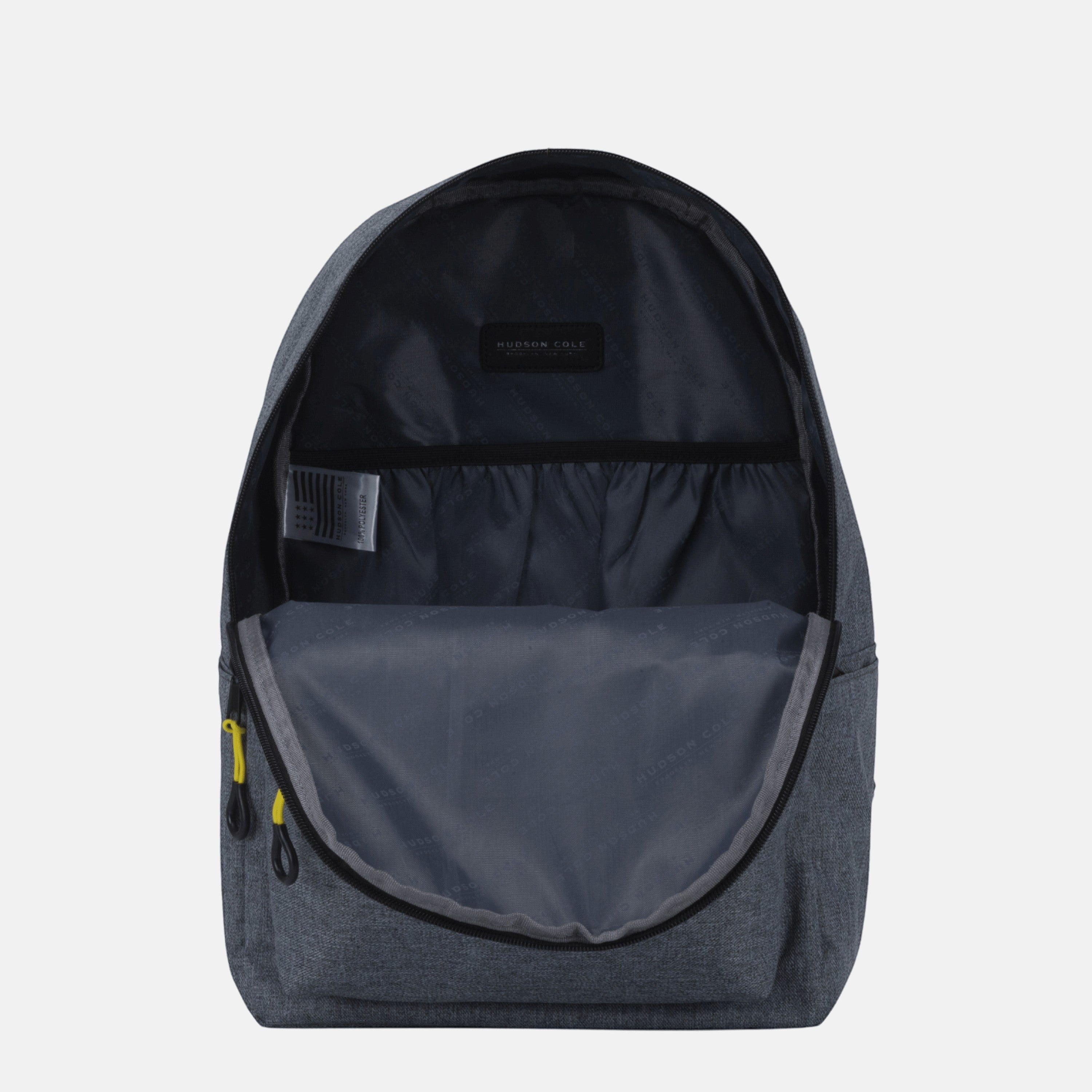 BirdieBox Hudson Cole Luna grey canvas backpack open, showing interior pockets and yellow zipper pulls.