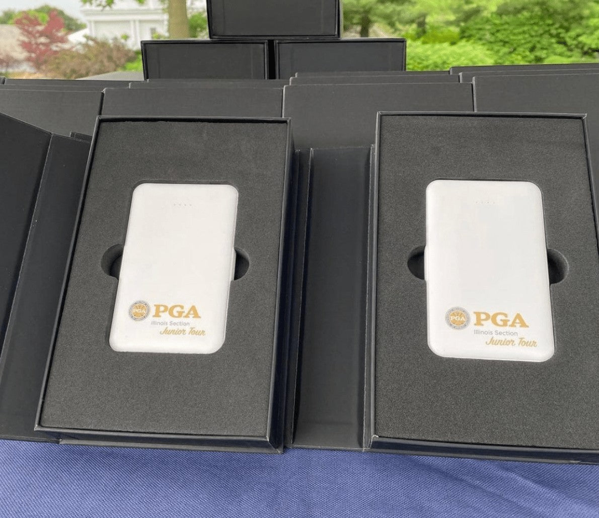BirdieBox white polymer powerbank with PGA Illinois Section Junior Tour logo, 5000 MAH capacity, battery indicator lights.
